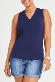 Model Noli wearing size 14 of The Classic Lace Trim Tank in colour Navy (Blue), from the front, cropped image