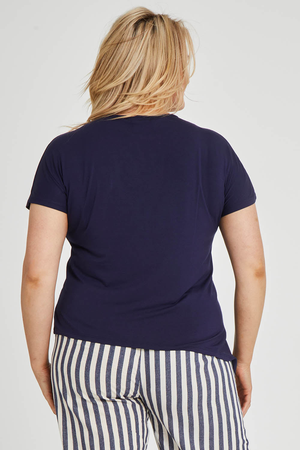 Model Keeara wearing size 16 of The Knot Detail Tee in colour Navy (Blue), from the back