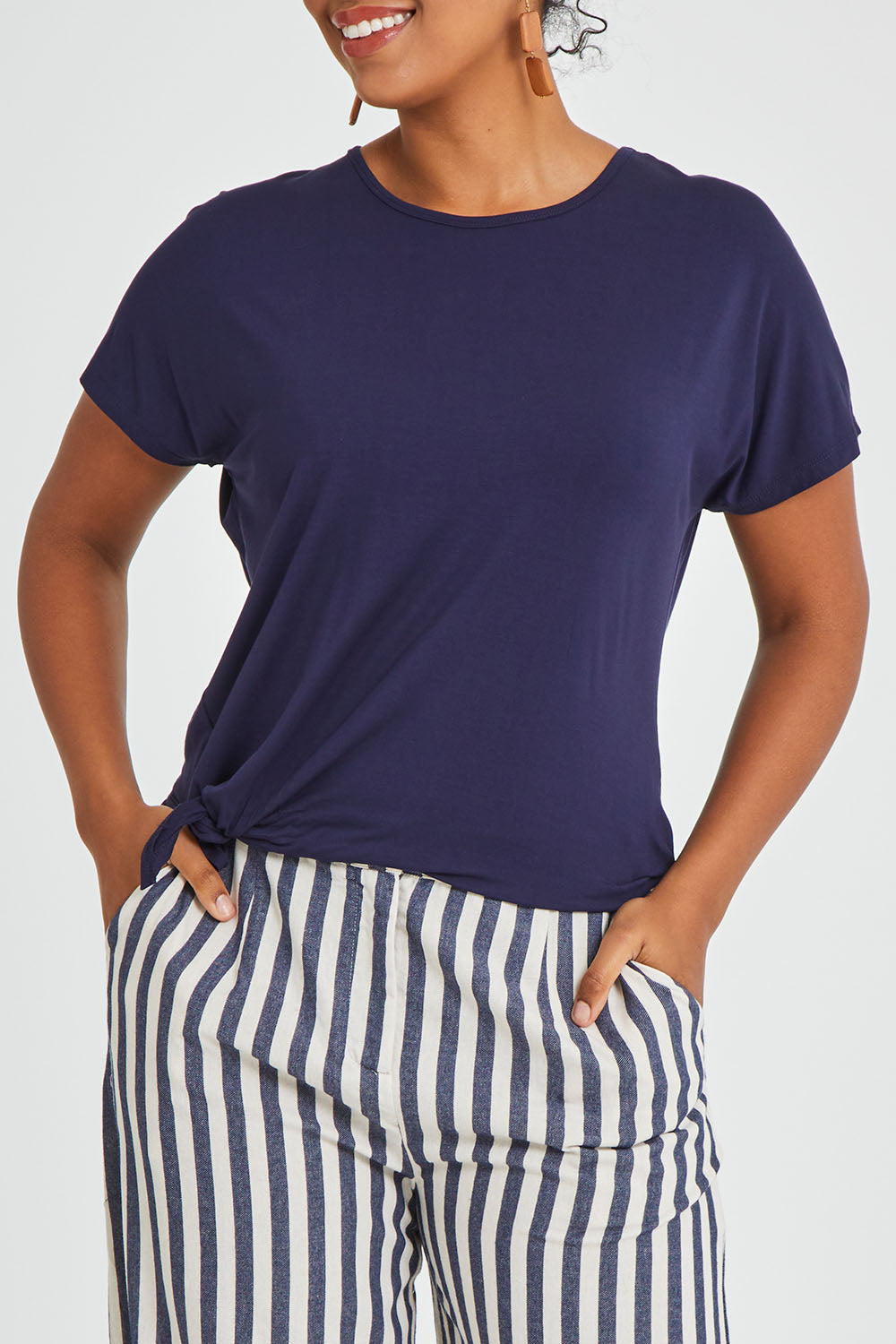 Model Noli wearing size 14 of The Knot Detail Tee in colour Navy (Blue), from the front, cropped image