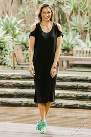 Model Amanda wearing size 10 of The Bamboo Cold Shoulder Dress in colour Black (Black), from the front, showing the whole outfit
