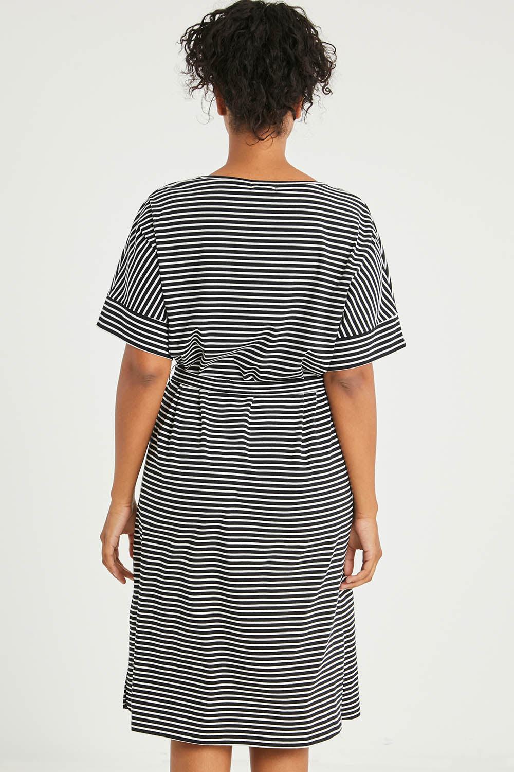 Model Noli wearing size 14 of The Striped Detail Dress in colour Blackwhite (Black), from the back