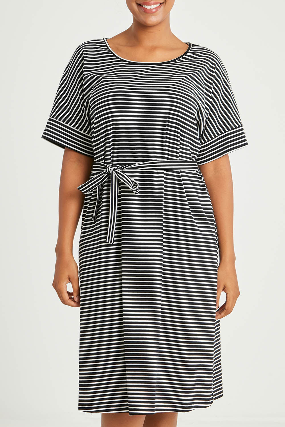 Model Noli wearing size 14 of The Striped Detail Dress in colour Blackwhite (Black), from the front, cropped image