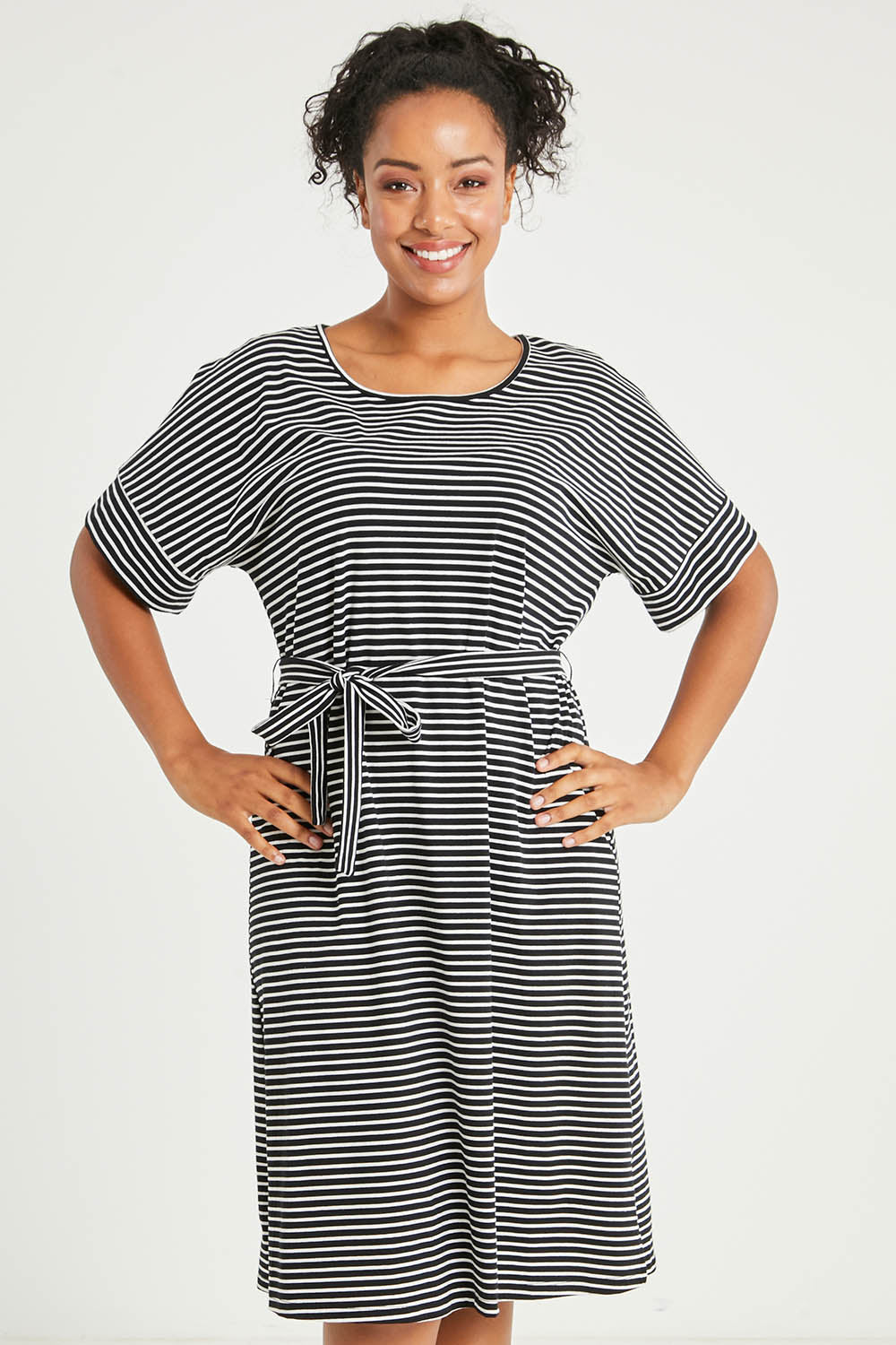 Model Noli wearing size 14 of The Striped Detail Dress in colour Blackwhite (Black), from the front, cropped image