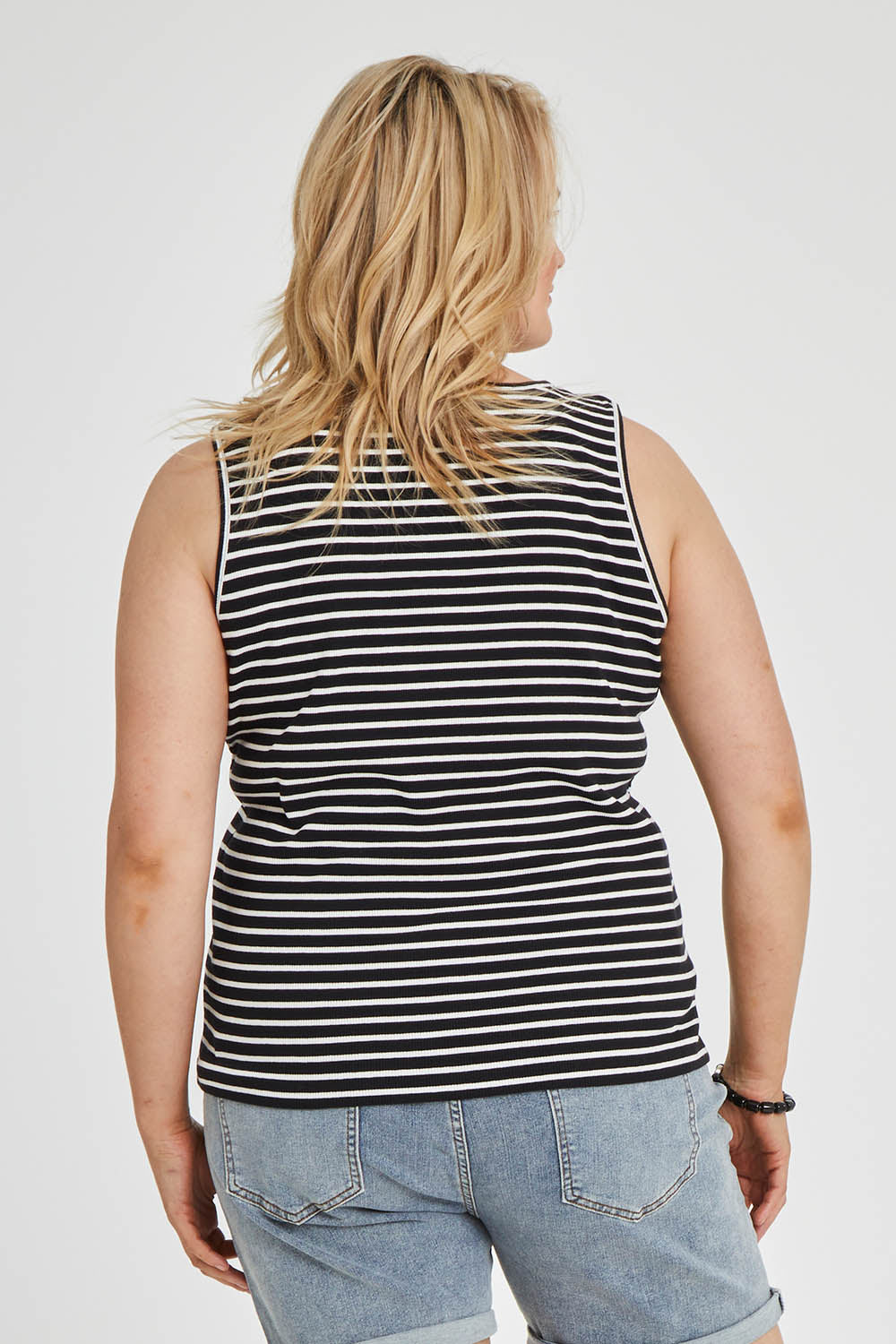 Model Keeara wearing size 16 of The Keepers Striped Rib Tank in colour Black (Black), from the back