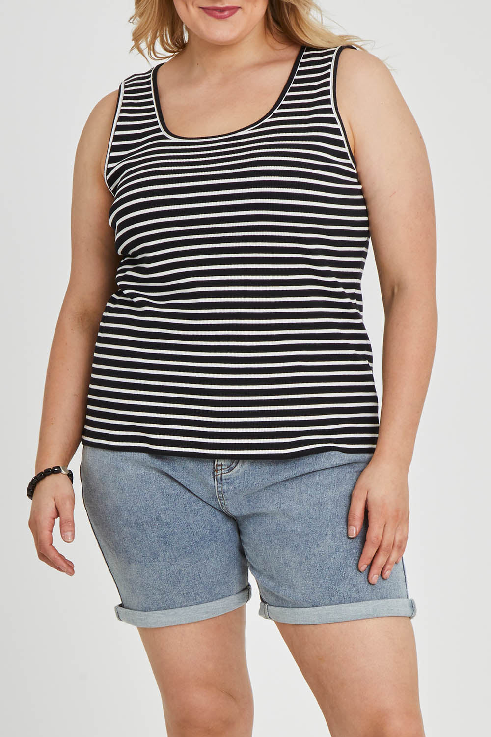 Model Keeara wearing size 16 of The Keepers Striped Rib Tank in colour Black (Black), from the front, cropped image