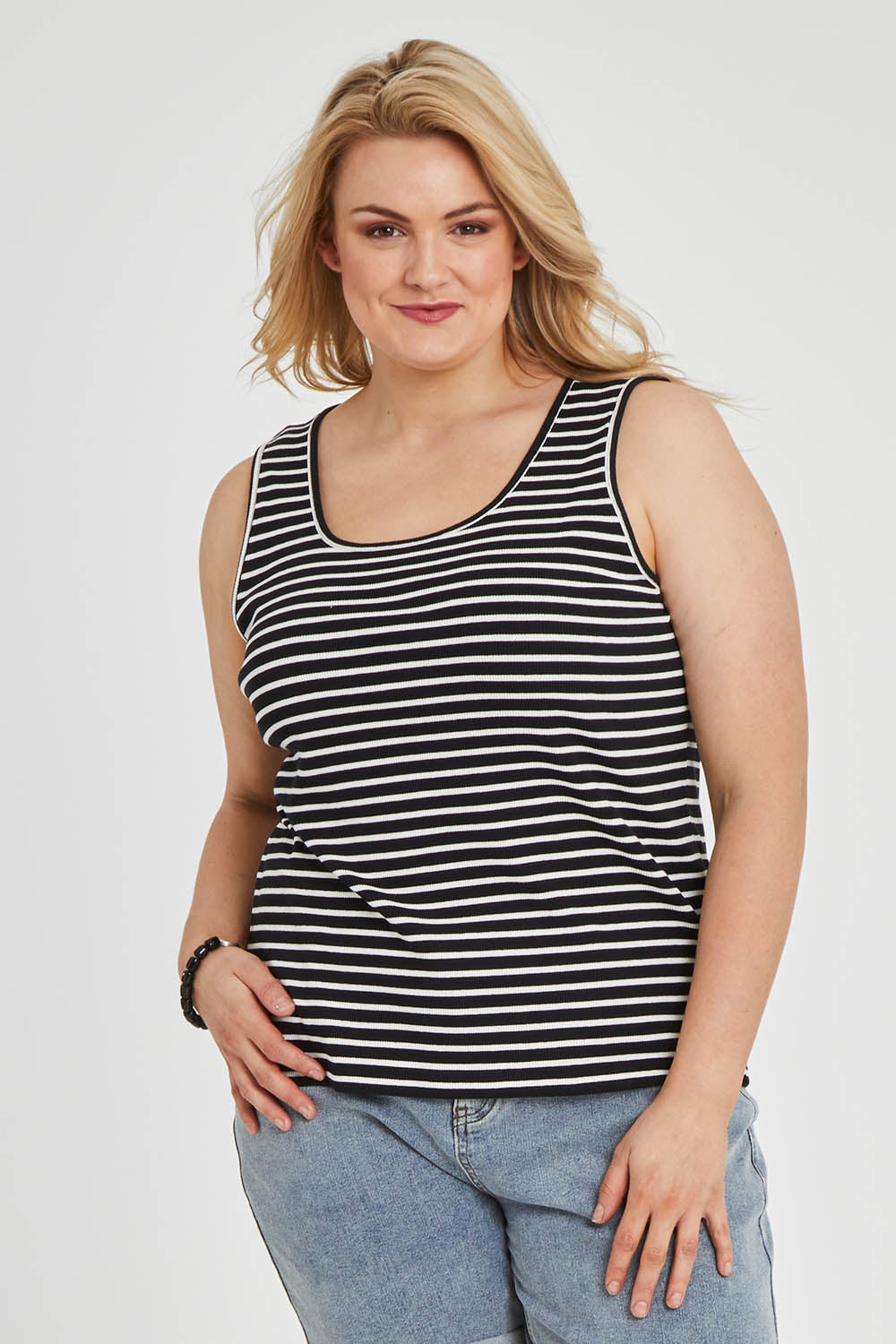 Model Keeara wearing size 16 of The Keepers Striped Rib Tank in colour Black (Black), from the front, cropped image