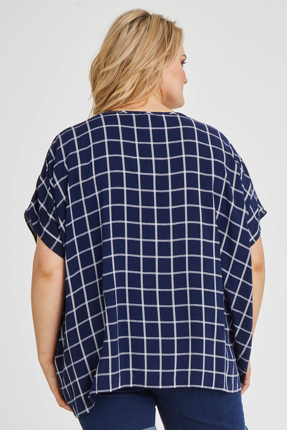 Model Keeara wearing size 16 of The Relaxed Fit Draped Top in colour Navywhite (Black), from the back