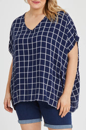 Model Keeara wearing size 16 of The Relaxed Fit Draped Top in colour Navywhite (Black), from the front, cropped image