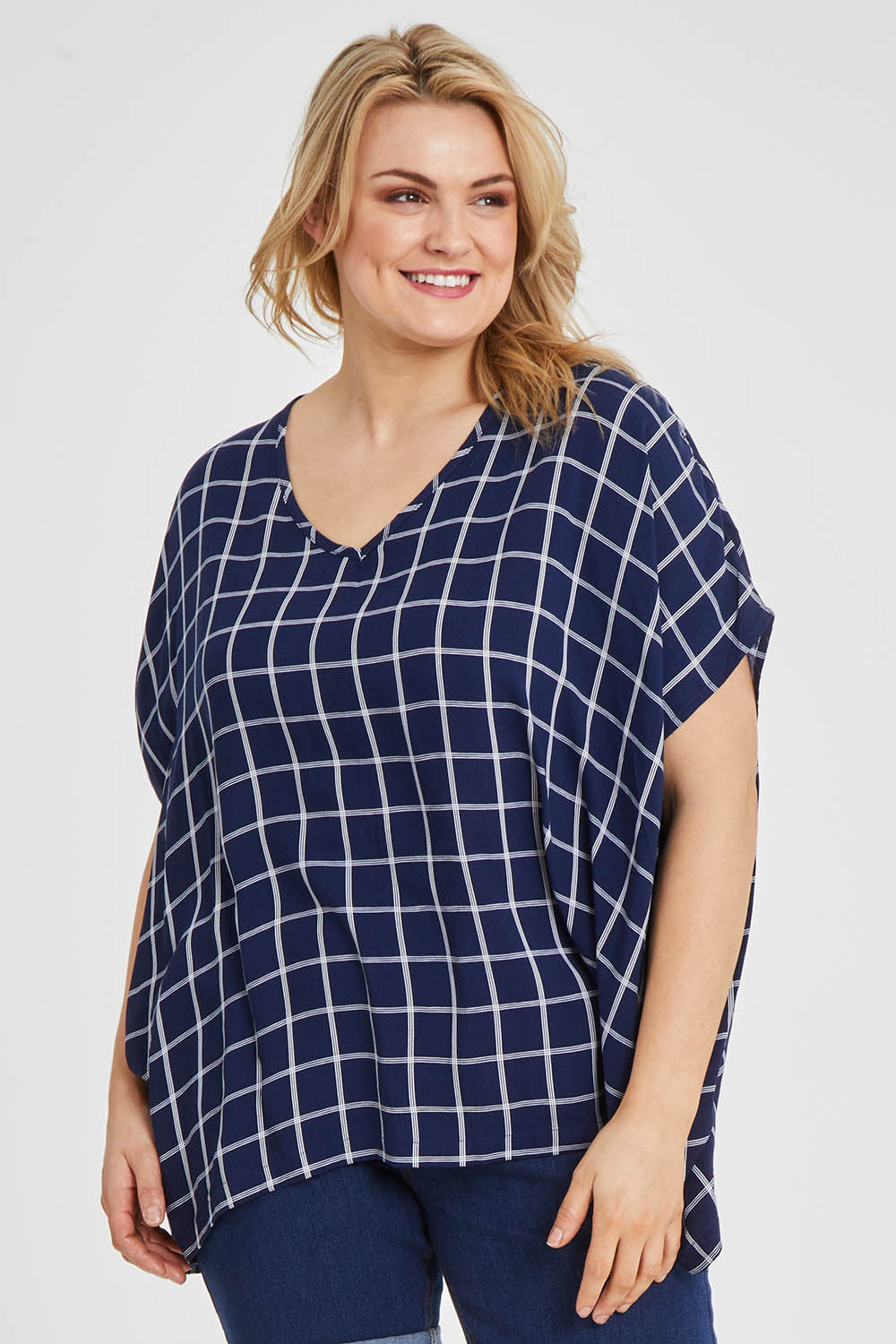 Model Keeara wearing size 16 of The Relaxed Fit Draped Top in colour Navywhite (Black), from the front, cropped image