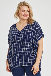 Model Keeara wearing size 16 of The Relaxed Fit Draped Top in colour Navywhite (Black), from the front, cropped image