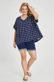 Model Keeara wearing size 16 of The Relaxed Fit Draped Top in colour Navywhite (Black), from the front, showing the whole outfit