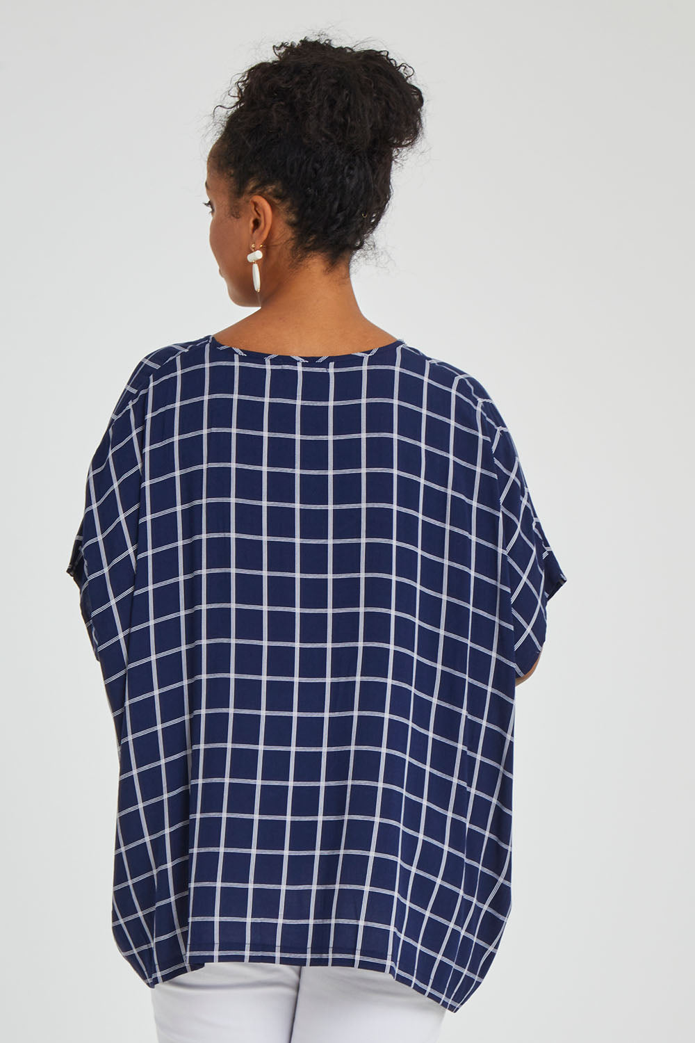 Model Noli wearing size 14 of The Relaxed Fit Draped Top in colour Navywhite (Black), from the back