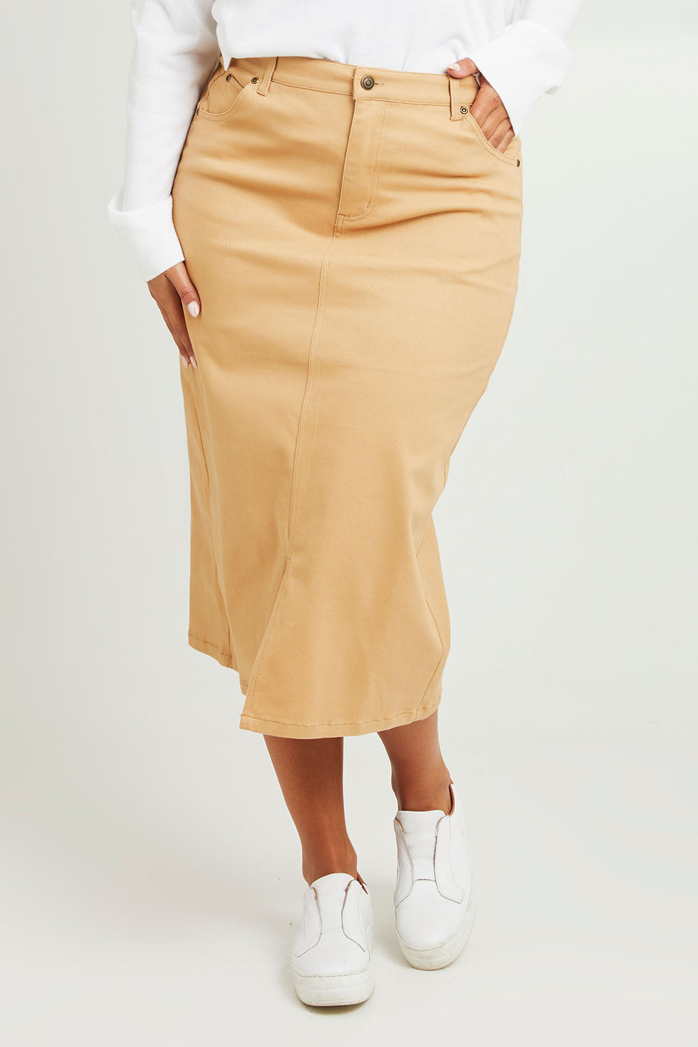 Model Monique wearing size 14 of The 5 Pocket Denim Midi Skirt in colour Tan, from the front, cropped image