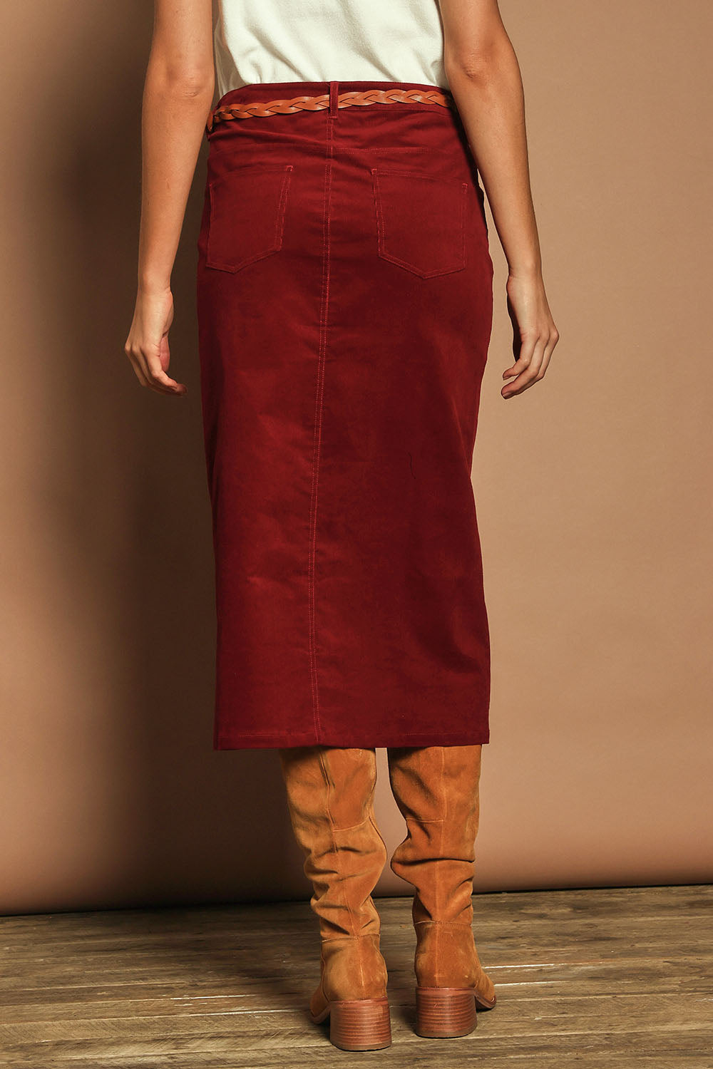 Model Madeline wearing size 10 of The 5 Pocket Cord Midi Skirt in colour Cherryred (Red), from the back