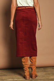 Model Madeline wearing size 10 of The 5 Pocket Cord Midi Skirt in colour Cherryred (Red), from the back
