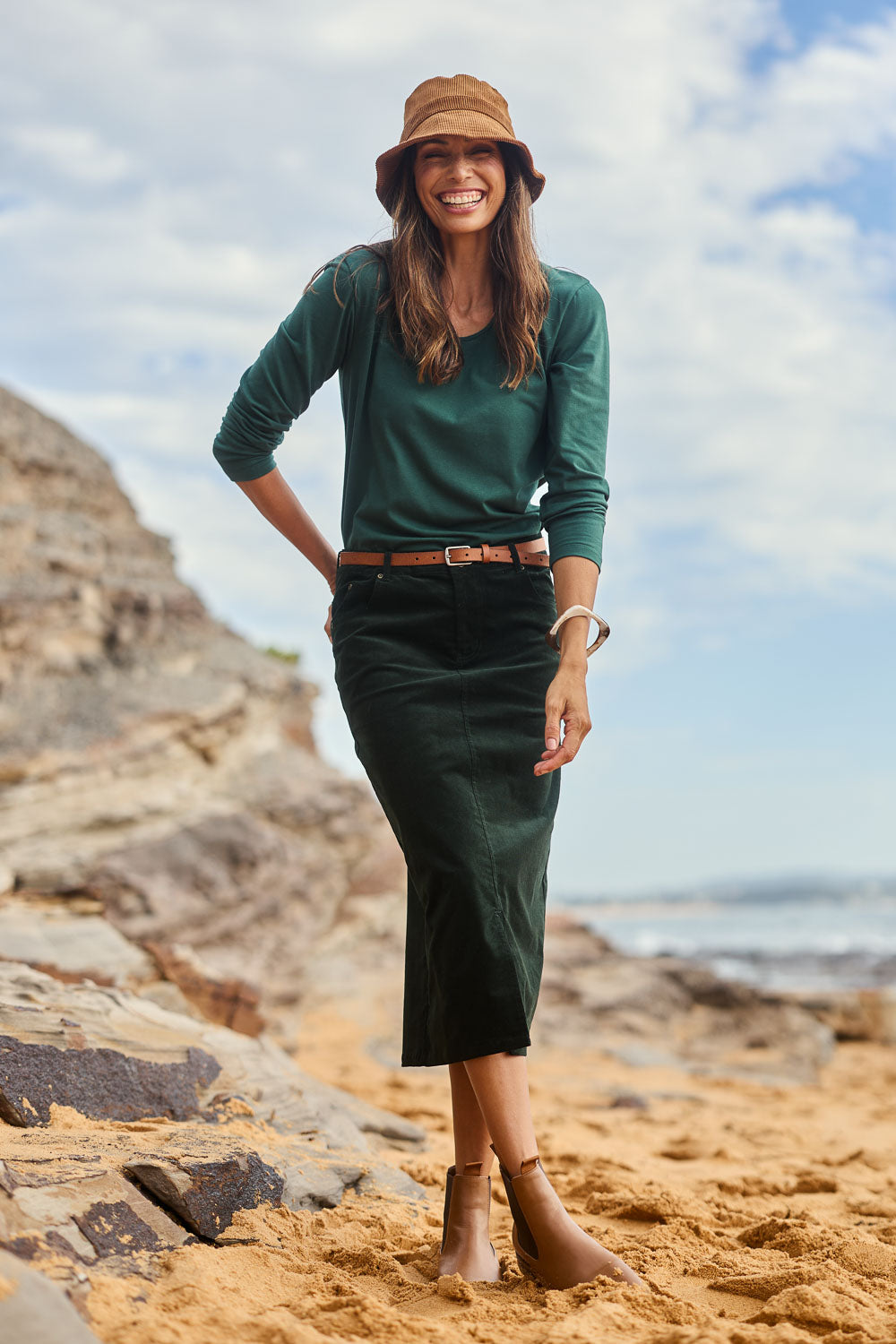 Model Amanda wearing size 10 of The 5 Pocket Cord Midi Skirt in colour Deepforest (Green), from the front, showing the whole outfit