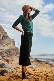 Model Amanda wearing size 10 of The 5 Pocket Cord Midi Skirt in colour Deepforest (Green), from the front, showing the whole outfit