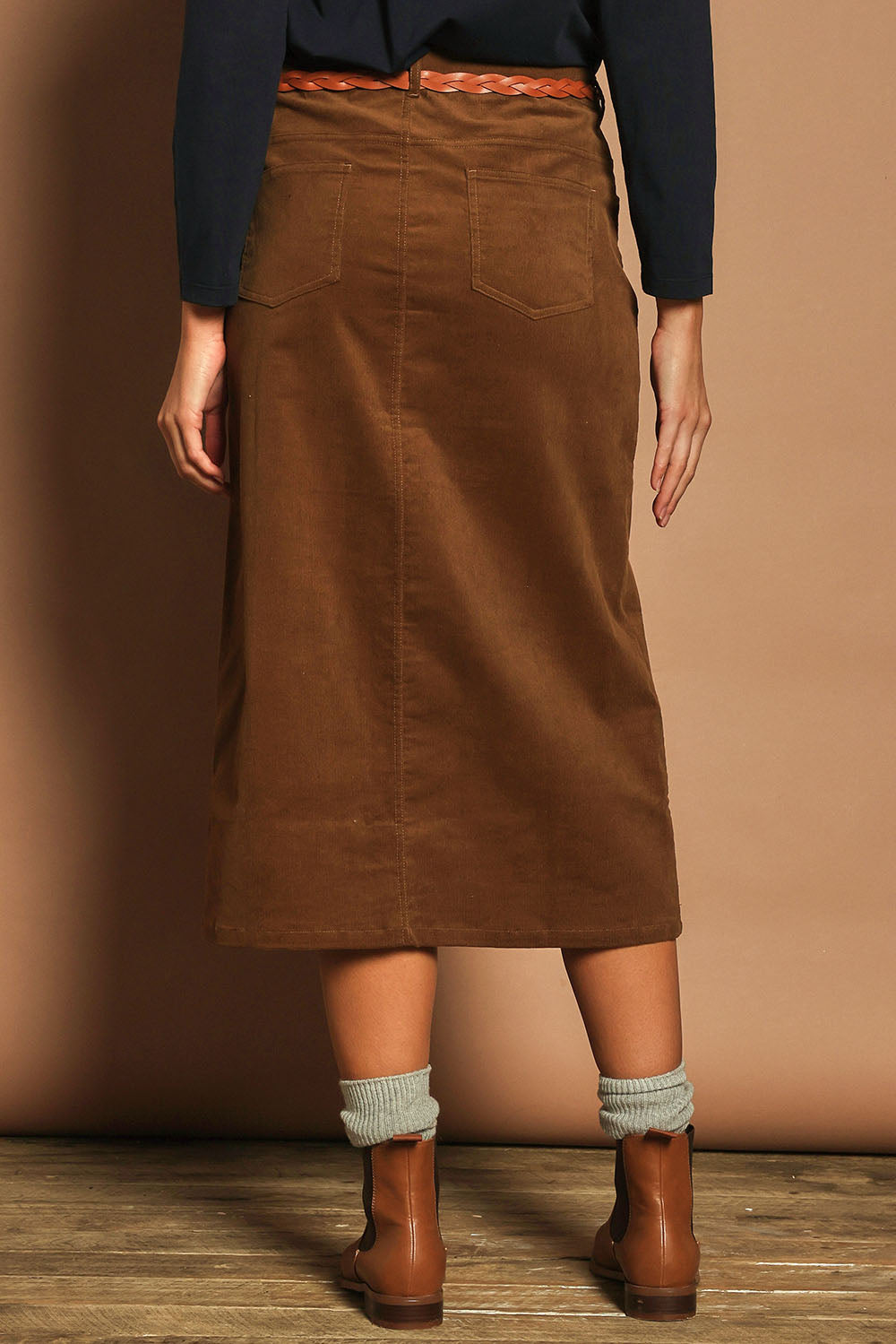 Model Madeline wearing size 10 of The 5 Pocket Cord Midi Skirt in colour Malt, from the back