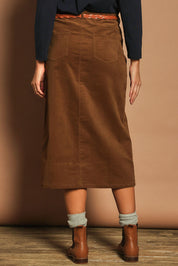 Model Madeline wearing size 10 of The 5 Pocket Cord Midi Skirt in colour Malt, from the back