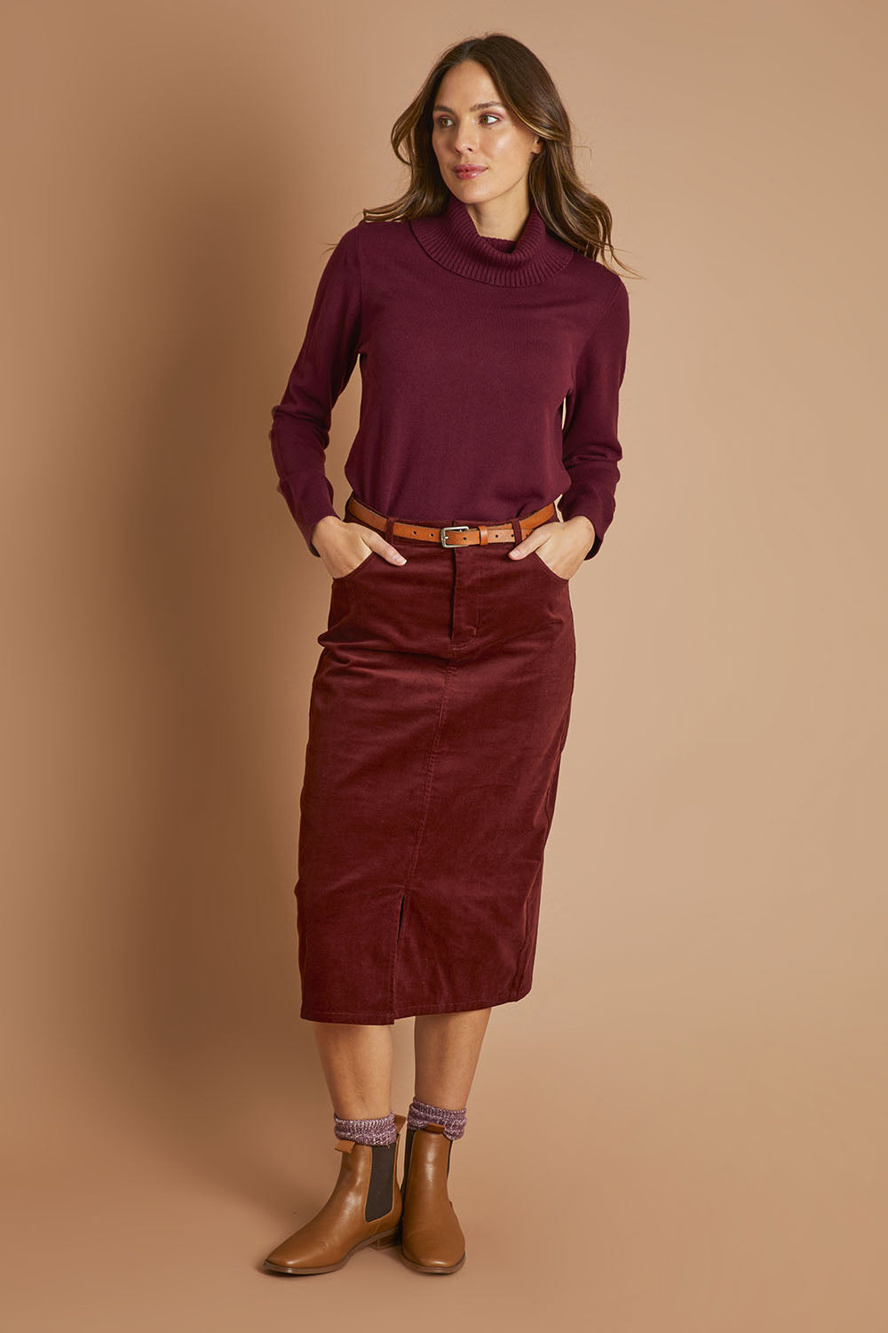 Model Madeline wearing size 10 of The 5 Pocket Cord Midi Skirt in colour Nutmeg, from the front, showing the whole outfit