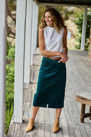 Model Emma wearing size 10 of The 5 Pocket Cord Midi Skirt in colour Petrol (Blue), from the front, showing the whole outfit