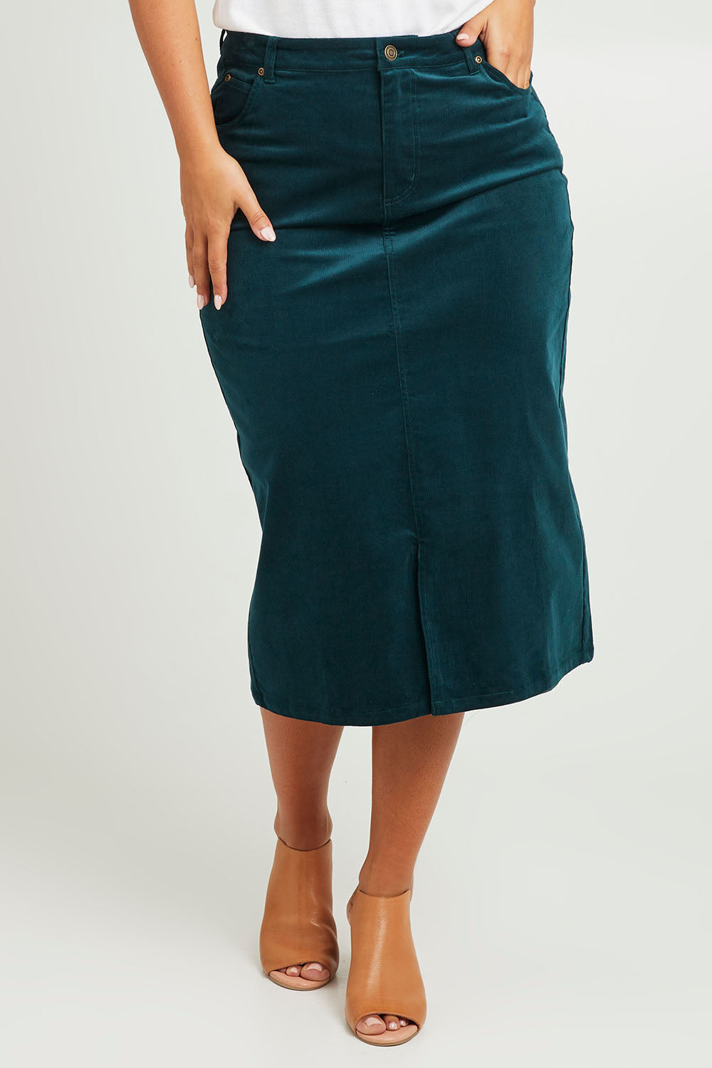 Model Monique wearing size 14 of The 5 Pocket Cord Midi Skirt in colour Petrol (Blue), from the front, cropped image