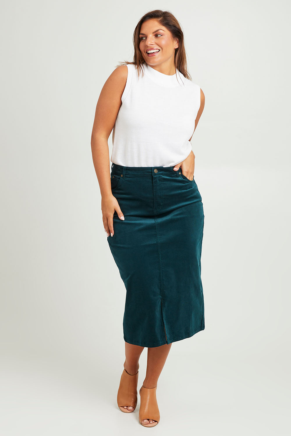 Model Monique wearing size 14 of The 5 Pocket Cord Midi Skirt in colour Petrol (Blue), from the front, showing the whole outfit