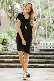 Model Amanda wearing size 10 of The Luxe Cotton Tee Dress in colour Black (Black), from the front, showing the whole outfit