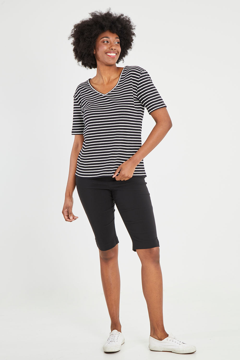 Model Aiyana wearing size 10 of The Keepers V Neck Striped Rib Tee in colour Black (Black), from the front, showing the whole outfit