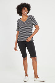 Model Aiyana wearing size 10 of The Keepers V Neck Striped Rib Tee in colour Black (Black), from the front, showing the whole outfit