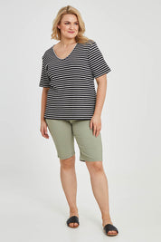 Model Keeara wearing size 16 of The Keepers V Neck Striped Rib Tee in colour Black (Black), from the front, showing the whole outfit