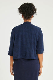 Model Noli wearing size 14 of The Lightweight Knit Shrug in colour Navy (Blue), from the back