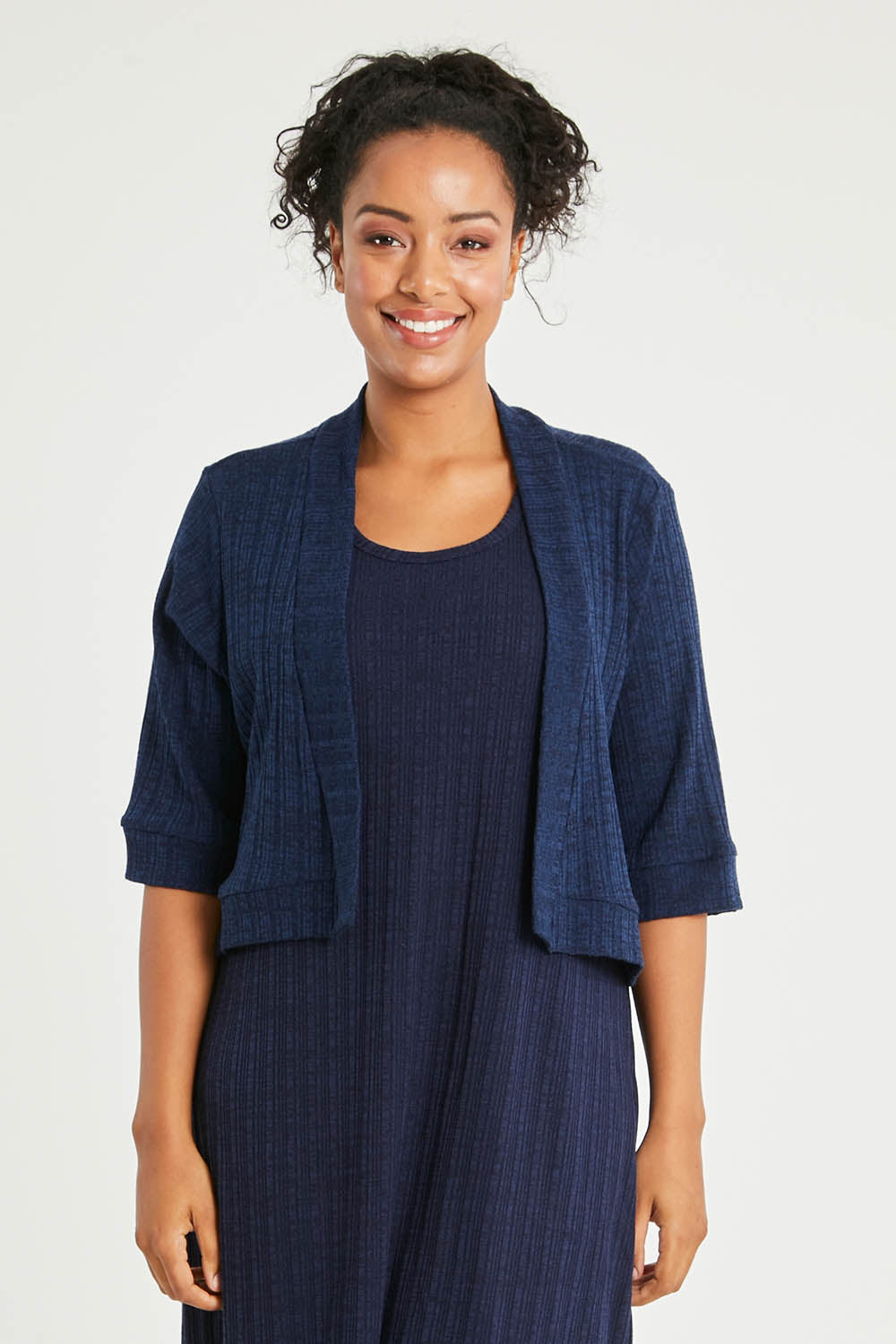 Model Noli wearing size 14 of The Lightweight Knit Shrug in colour Navy (Blue), from the front, cropped image
