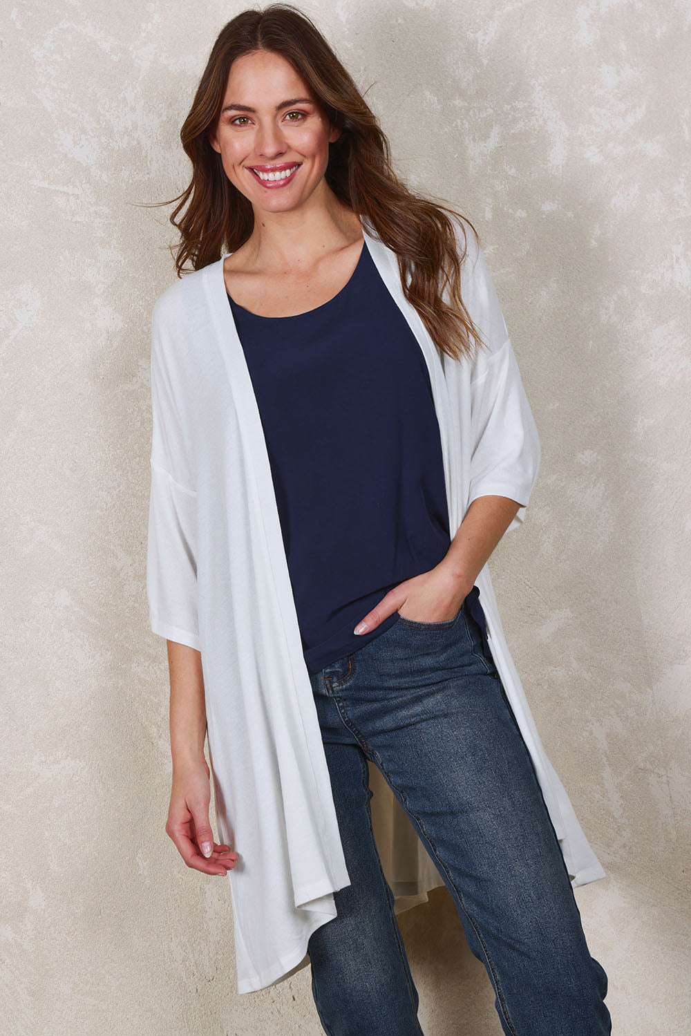 Model Madeline wearing size 10 of The Perfect Summer Knit Cardi in colour White (White), from the front, showing the whole outfit