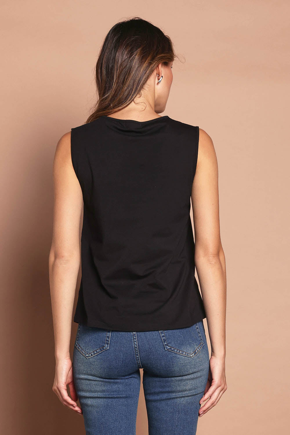 Model Madeline wearing size 10 of The Keepers Classic Tank in colour Black (Black), from the back
