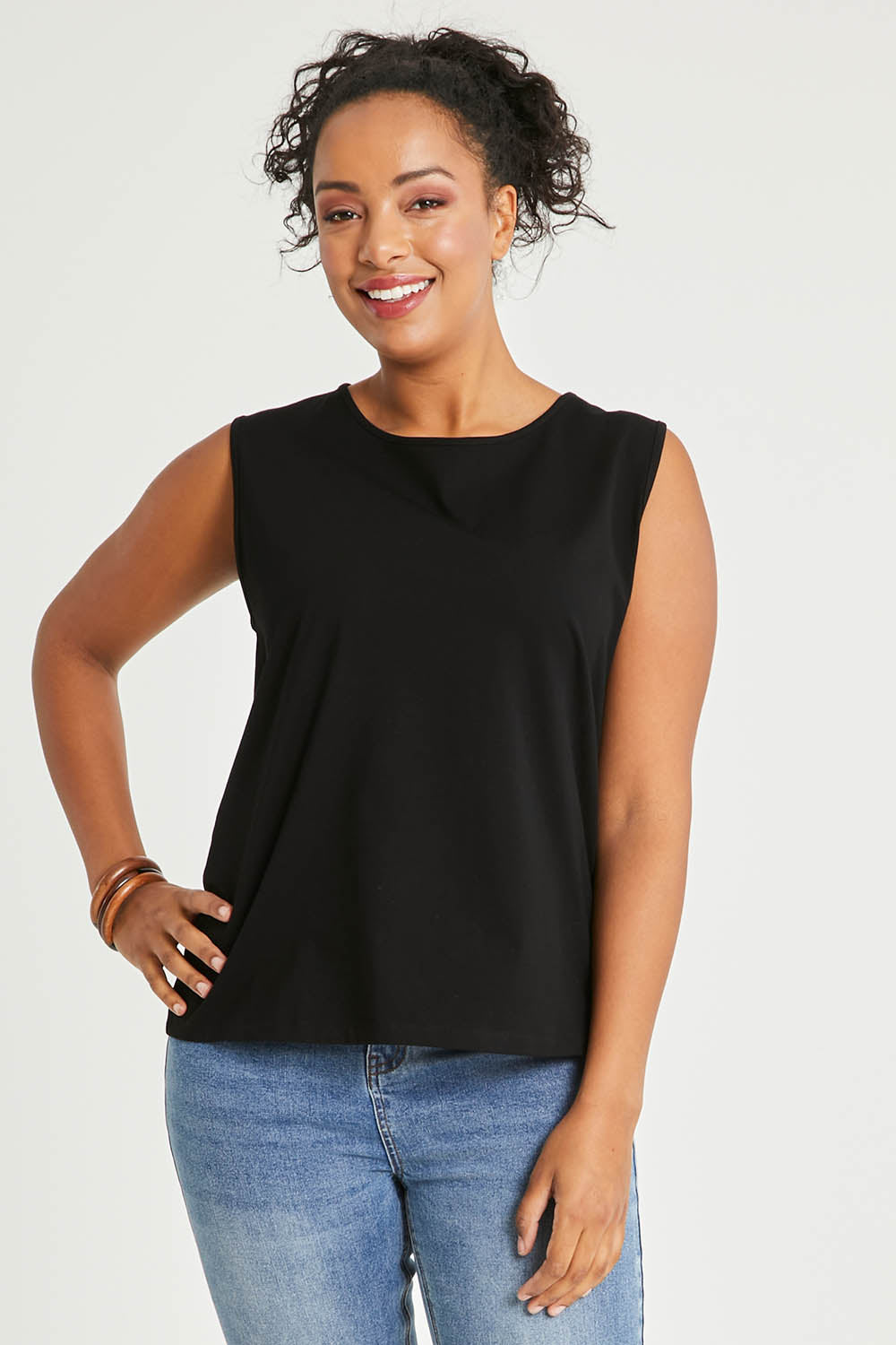 Model Noli wearing size 14 of The Keepers Classic Tank in colour Black (Black), from the front, cropped image