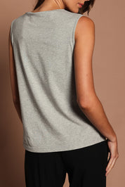 Model Madeline wearing size 10 of The Keepers Classic Tank in colour Greymarle (Grey), from the back