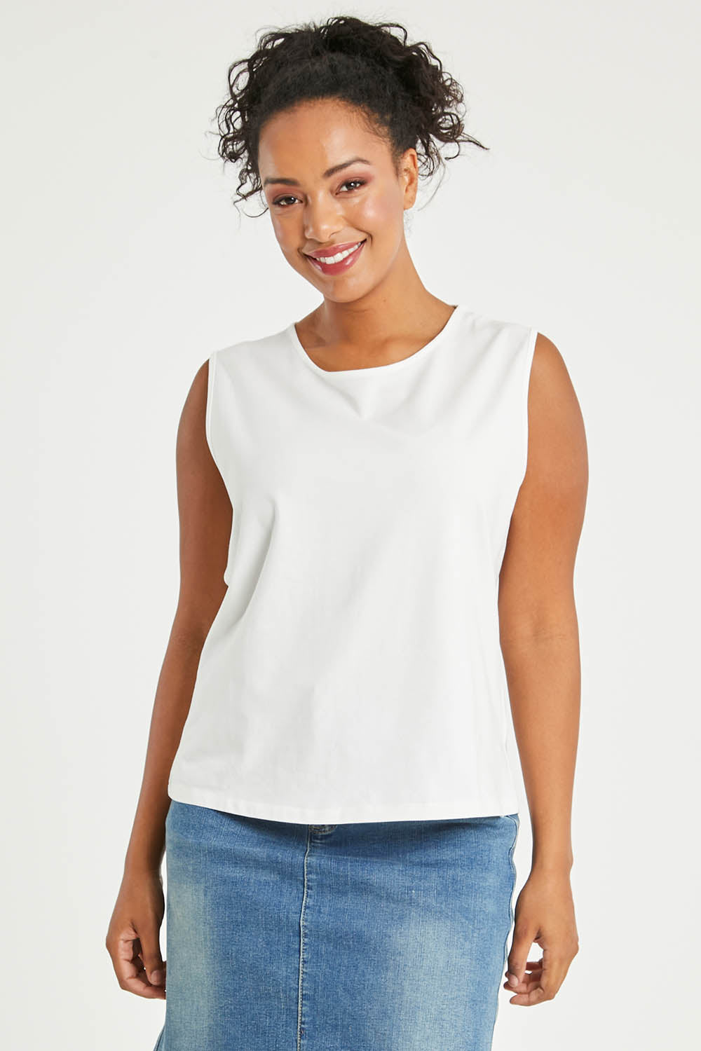 Model Noli wearing size 14 of The Keepers Classic Tank in colour White (White), from the front, cropped image