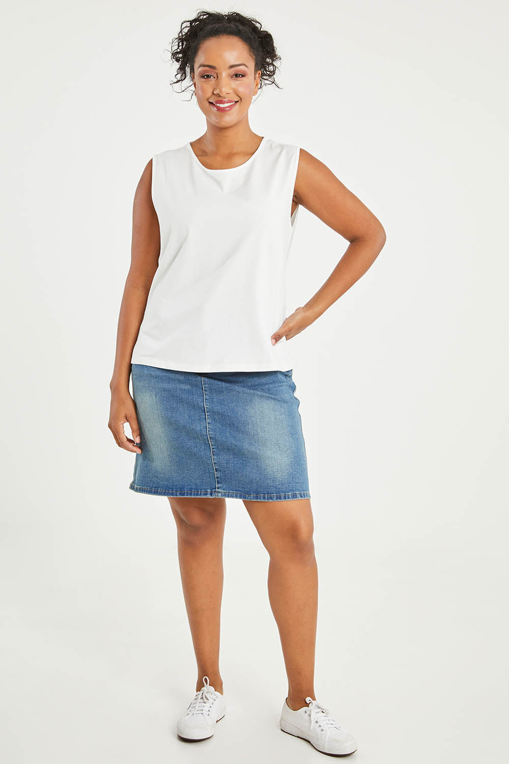 Model Noli wearing size 14 of The Keepers Classic Tank in colour White (White), from the front, showing the whole outfit
