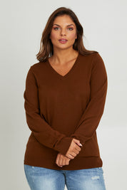 Model Monique wearing size L of The Keepers Soft V Neck Jumper in colour Bark, from the front, cropped image