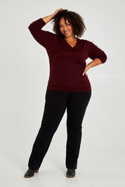 Model Alexis wearing size XL of The Keepers Soft V Neck Jumper in colour Burgundy (Purple), from the front, showing the whole outfit