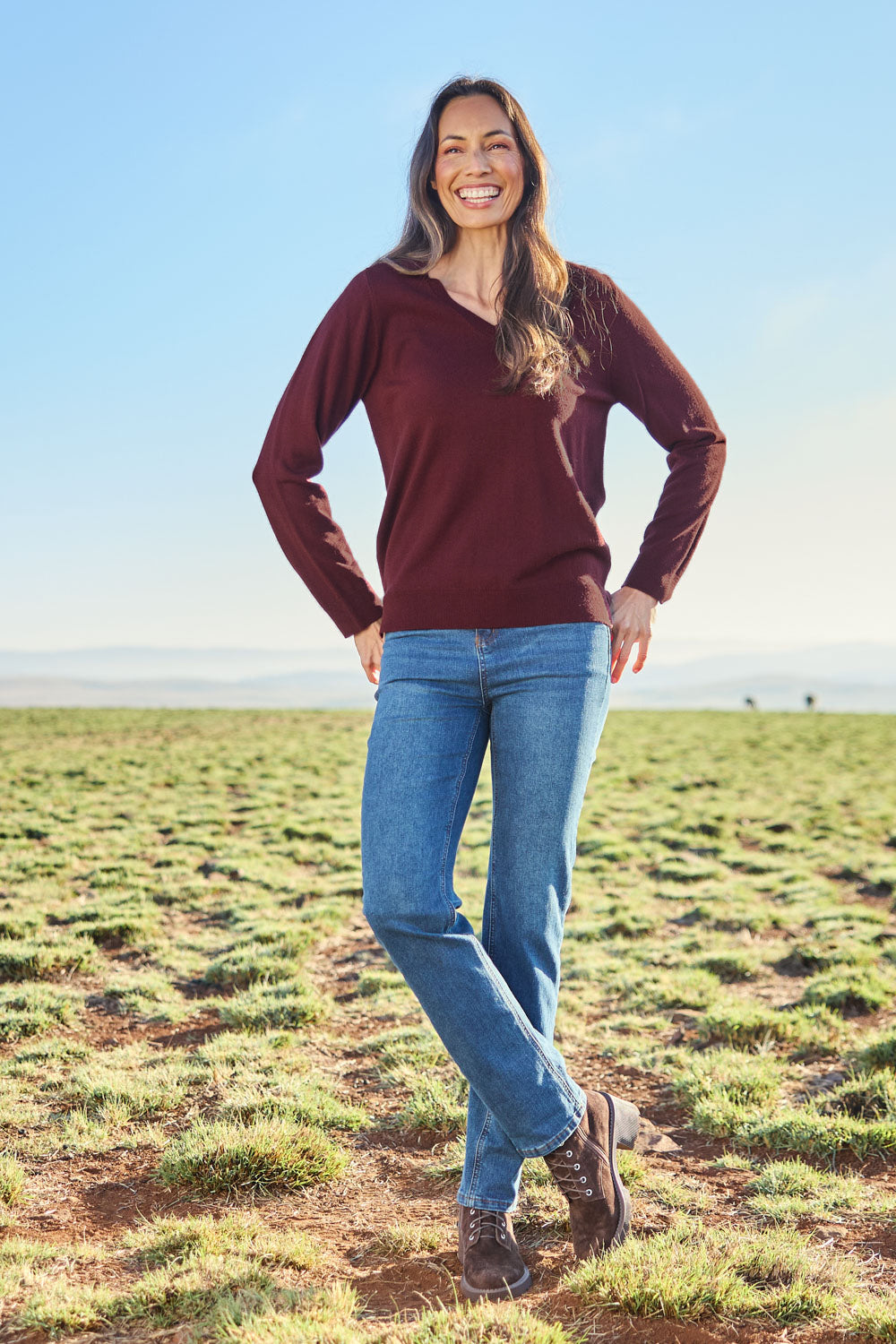 Model Amanda wearing size S of The Keepers Soft V Neck Jumper in colour Burgundy (Purple), from the front, showing the whole outfit