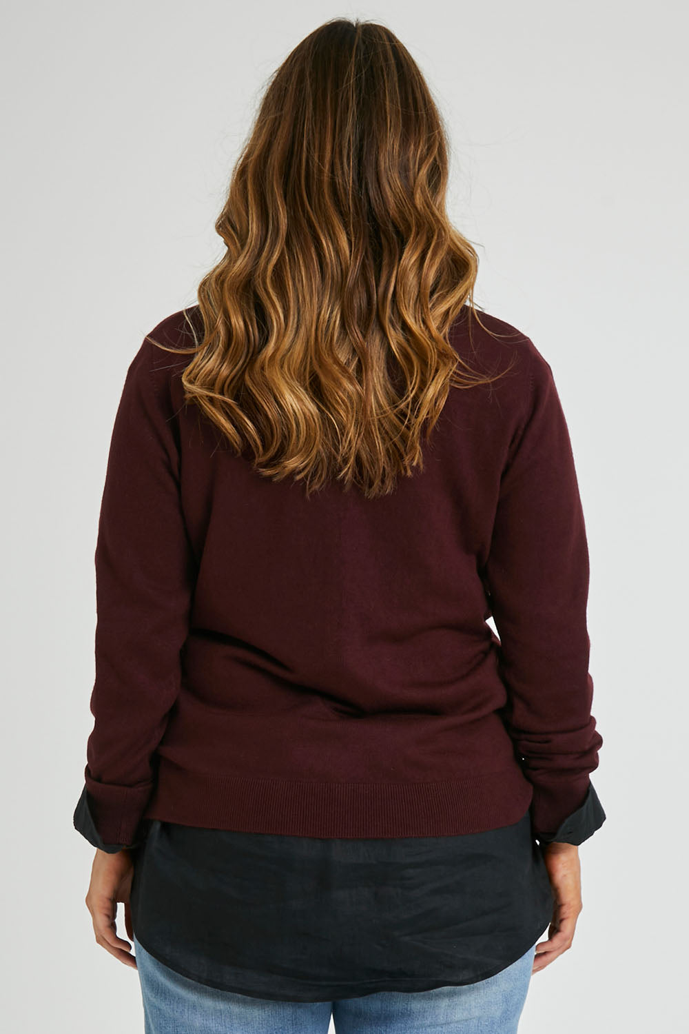 Model Laura wearing size L of The Keepers Soft V Neck Jumper in colour Burgundy (Purple), from the back