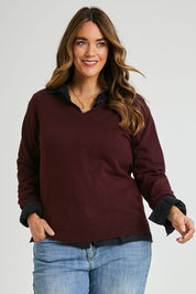 Model Laura wearing size L of The Keepers Soft V Neck Jumper in colour Burgundy (Purple), from the front, cropped image
