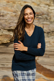 Model Amanda wearing size S of The Keepers Soft V Neck Jumper in colour Denim (Blue), from the front, showing the whole outfit