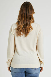Model Laura wearing size L of The Keepers Soft V Neck Jumper in colour Ivory (White), from the back