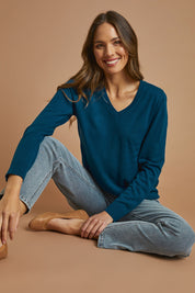Model Madeline wearing size S of The Keepers Soft V Neck Jumper in colour Petrol (Blue), from the front, showing the whole outfit
