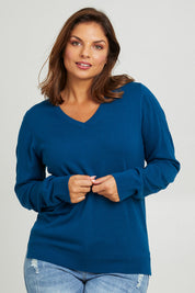 Model Monique wearing size L of The Keepers Soft V Neck Jumper in colour Petrol (Blue), from the front, cropped image