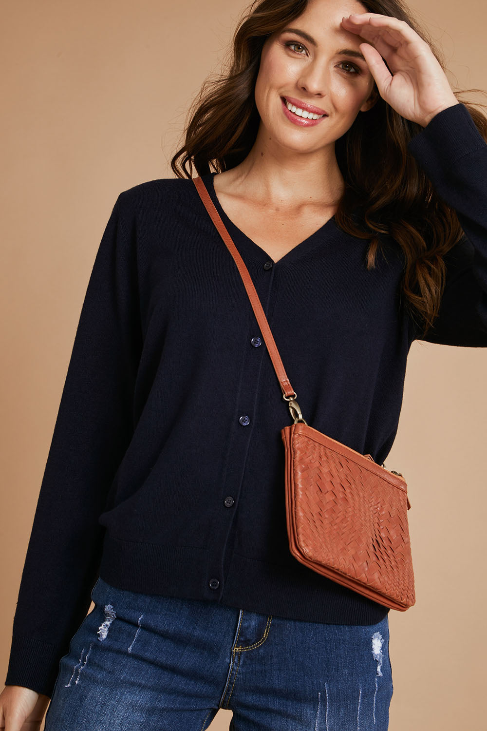 Model Madeline wearing size S of The Keepers Soft Button Up Cardigan in colour Deepnavy (Blue), from the front, showing the whole outfit