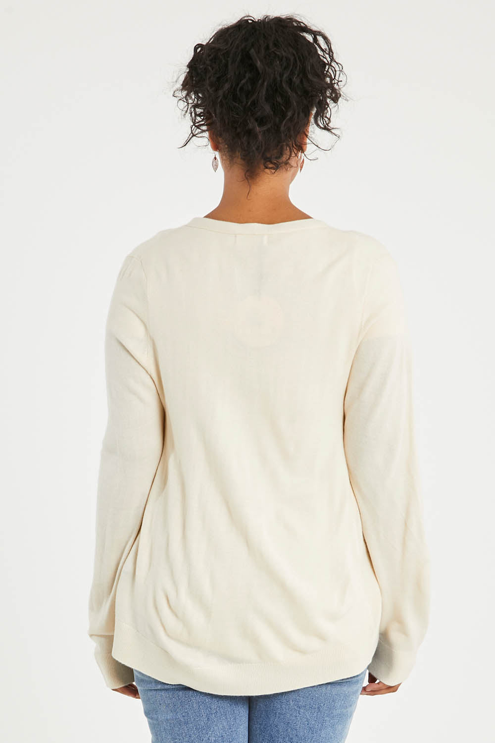 Model Noli wearing size L of The Keepers Soft Button Up Cardigan in colour Ivory (White), from the back